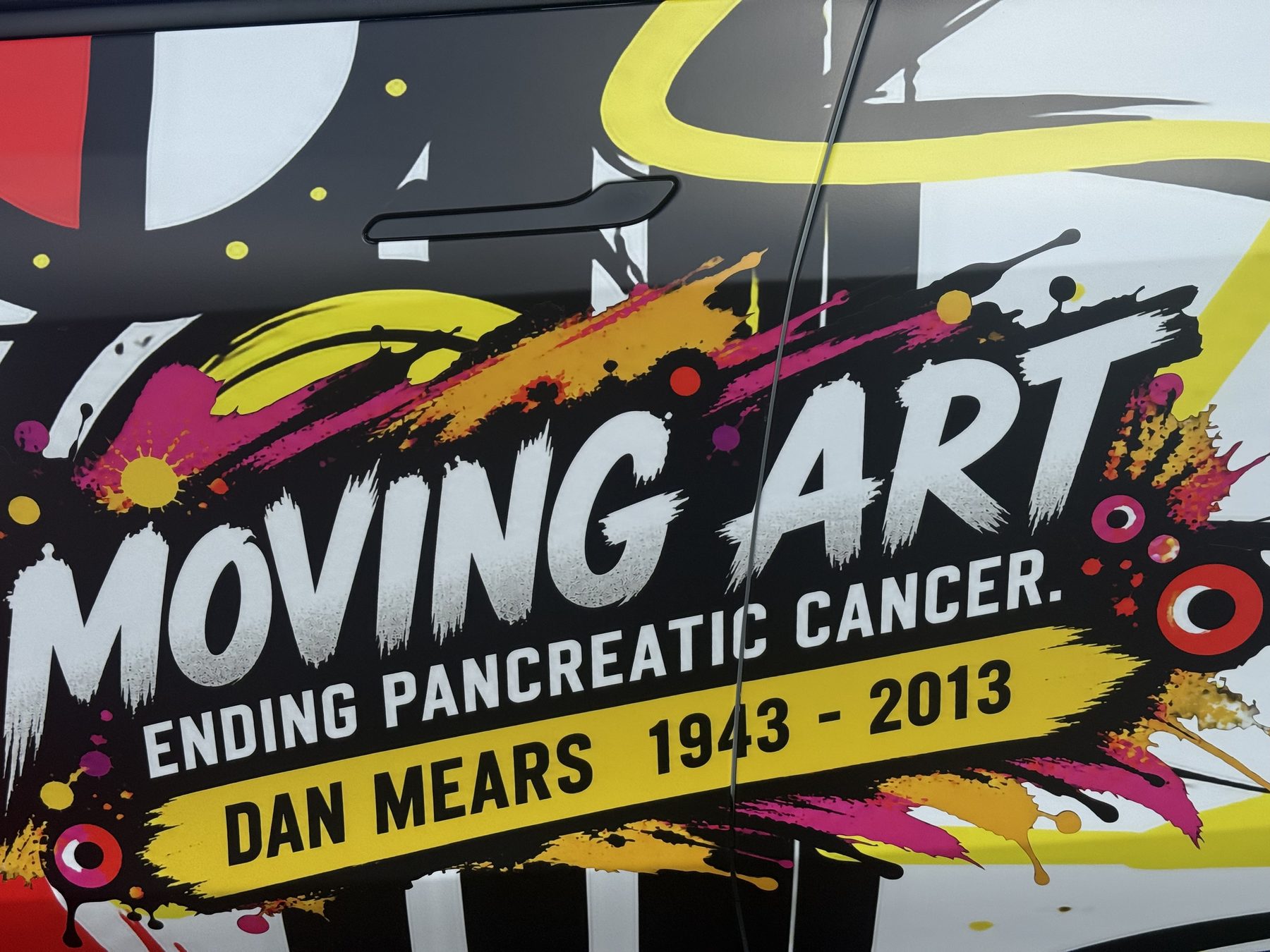 Close-up of the Moving Art door graphic reading Ending Pancreatic Cancer, Dan Mears 1943 to 2013